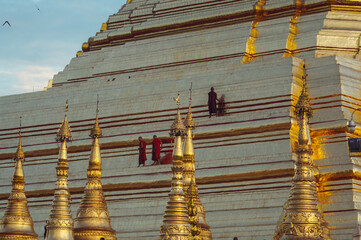 a group of people standing on a building with towers and towers