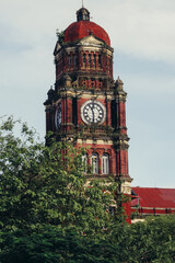 a clock tower with a red roof