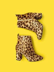 Flat lay shooting of catchy female boots with high heels and leopard print placed on trendy...