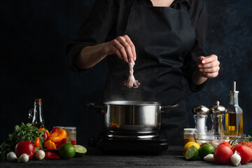 The professional chef puts raw octopus into pan with boiling water. Backstage of cooking...