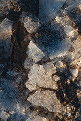 Obraz na płótnie Canvas Ice and snow on the beach at sunset.The texture of the ice.