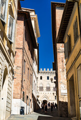 Fototapeta na wymiar Narrow medieval street in Siena - Tuscany, Italy
