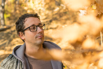 Portrait of young man with glasses in forest