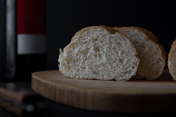 Fresh bread sliced baguette in black background
