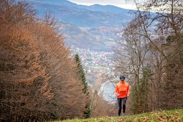 Obraz premium Woman runner runs uphill. Training in the mountains.