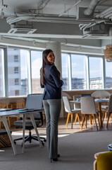 Portrait of a smiling businesswoman standing in an office.