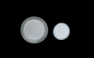 white paint can top view black background