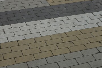 gray brown stone texture of paving slabs on the alley of the road on the street