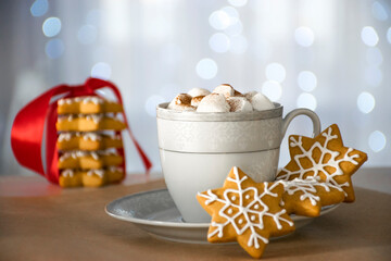 Traditional Christmas handmade gingerbread cookie and cup of hot winter drink with marshmallow, stack of cookie and bokeh on background. Christmas food and drink, cozy atmosphere, winter miracle.