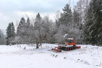 Snow groomer in a mountains at winter