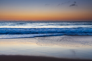 Fototapeta premium Hazy sunrise seascape with low swell