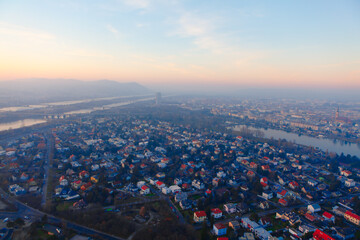 Naklejka premium Viennese surroundings in the evening with Danube river . Aerial view of Austrian Capital City 
