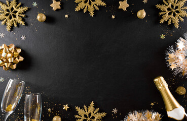 Christmas and New Year holidays background concept made from champagne, glasses, stars, snow flake with golden glitter on black wooden background. - Powered by Adobe