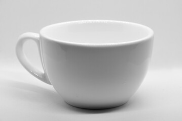White cup on light background with selective focus