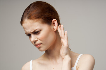 disgruntled woman holding her ear health problems close-up