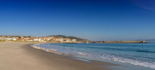 the beach and harbor in the fishing village of Laxe in western Galicia