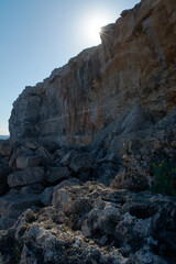 Fototapeta na wymiar starry sun, on cliff, limestone rock, with blue sky, rockfall,