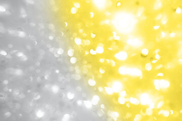 Bright Colorful bokeh light on Ultimate Gray and Illuminating yellow background. Color of the year 2021.