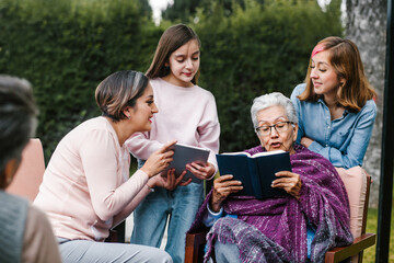 latina women family reading a book in a backyard outside home in Mexico city