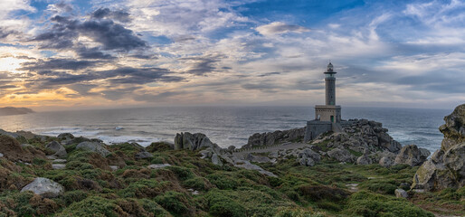 panorama view of the Punta Nariga lighthouse during a beautiful sunset on the coast of Galicia