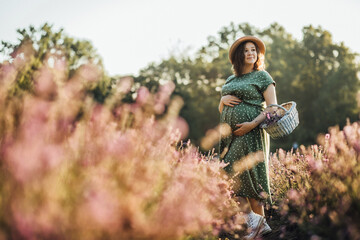 woman, nature, young, outdoors, beauty, happy, beautiful, park, people, smiling, forest, grass, green, autumn, happiness, child, smile, senior, sitting, person, summer, portrait, A pregnant woman. 