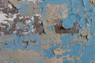 Peeling paint on the wall. Old concrete wall with cracked flaking paint. Weathered rough painted...