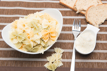 plate of pasta bows with parmesan cheese