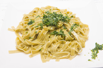 plate of noodles with grated cheese and pesto