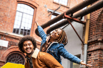 Happy smiling couple having fun outdoor, smiling and looking to the camera.