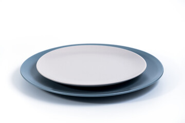 Dish set - Large Navy Blue and small Grey plates isolated on white background side view, selective focus