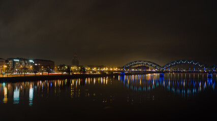 Obraz premium Riga,Latvia,Europe, night views of the city and the railway bridge