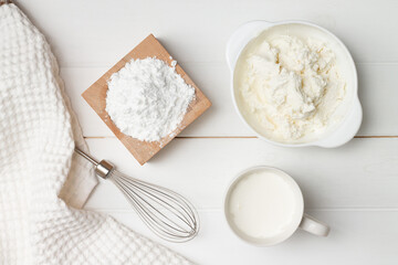 Obraz na płótnie Canvas Step-by-step heart-shaped cake recipe instructions. Step 6, ingredients for the cream. Powdered sugar, ricotta, cream.