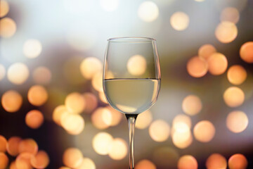 wine glass filled with sparkling fluid on bokeh backgroung magic concept