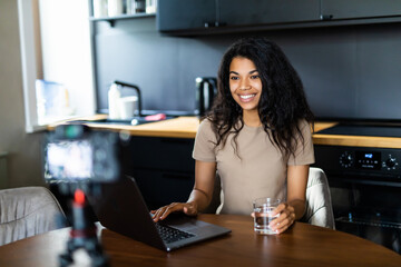 African American blogger recording video about sport and healthy food at home
