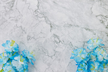 Modern Clean Flat Lay or Top View Office Desk or Office Table and Blue Flower at Bottom on Marble Minimalist Background