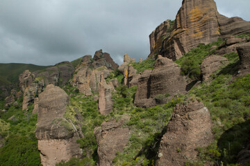Fototapeta na wymiar Jurassic landscape. Panorama view of the mountains, green forest and rock formations called Los Terrones, in Cordoba, Argentina.