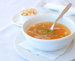 traditional chicken soup served in a bowl over white background