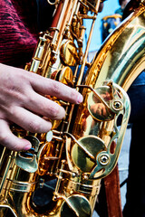 hand and saxophone details in a band, music show