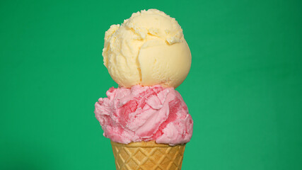 Vanilla on top Ice cream Strawberry cone on green background, Closeup Front view Food concept.