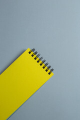 Yellow notepad with blank page for text on gray background. Minimalistic banner with colors of the year 2021 - Illuminating and Ultimate Gray. - 398375603