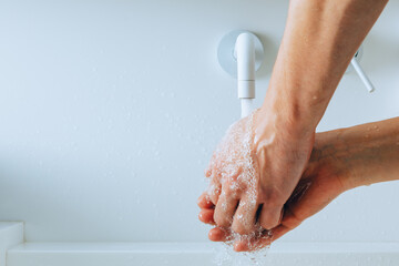 Fototapeta premium hands washing under the faucet with flowing water