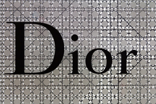 Christian Dior sign on a grey background