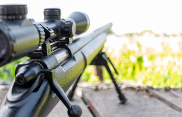 Close up rifle scope with forest background