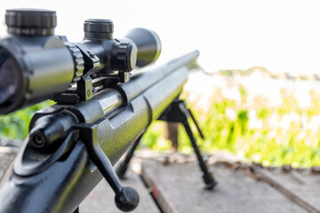Close up rifle scope with forest background