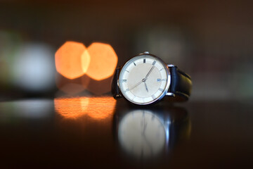 Leather strap watches are placed on the floor.