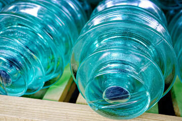 Glass insulators for high-voltage electric poles are on the shelf. Storage of materials for electrification in a warehouse