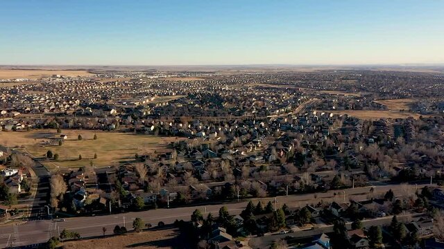 Drone view over Colorado Springs neighborhood houses park and traffic