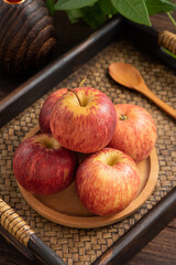 Fresh fruits and small apples on the background of retro Chinese style tea tray