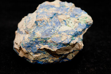 blue azurite and green malachite mineral sample on a bla