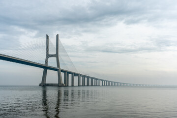 view of Vasco da Gama bridge in Lisbon, Portugal, on a foggy day.